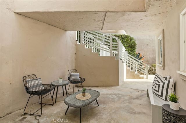 a view of a chairs and table in patio