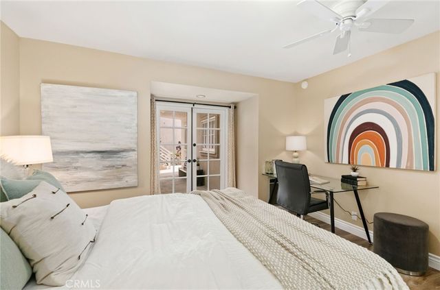 a bedroom with a bed and a large window with the dresser