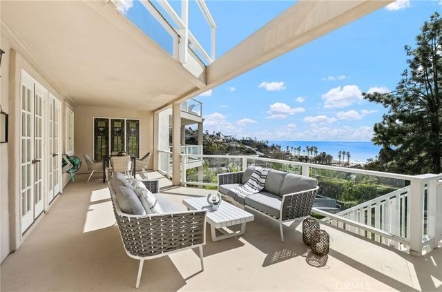 a view of a patio with couches chairs and a potted plant