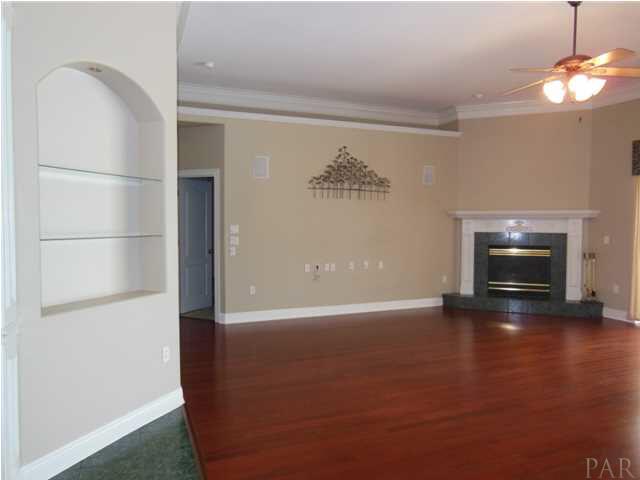 1621 West 9 & Half Mile Road Cantonment, FL 32533 - Photo 6 of 25 The cherry floors of the great room lead to the corner fireplace.
