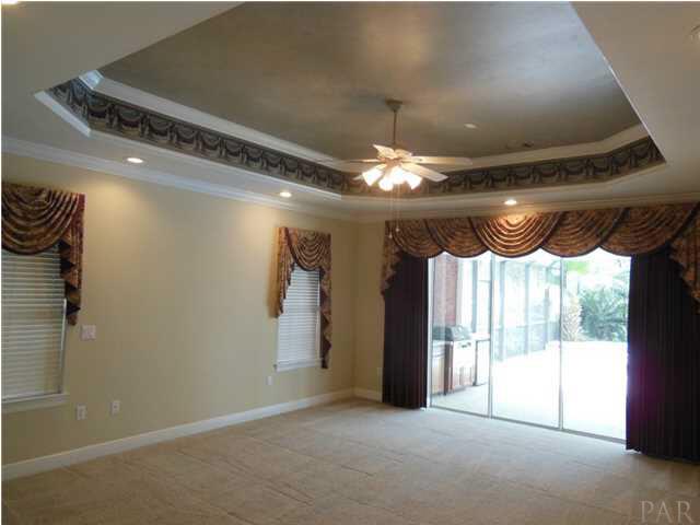 1621 West 9 & Half Mile Road Cantonment, FL 32533 - Photo 10 of 25 The master bedroom has triple sliding doors to the pool lanai