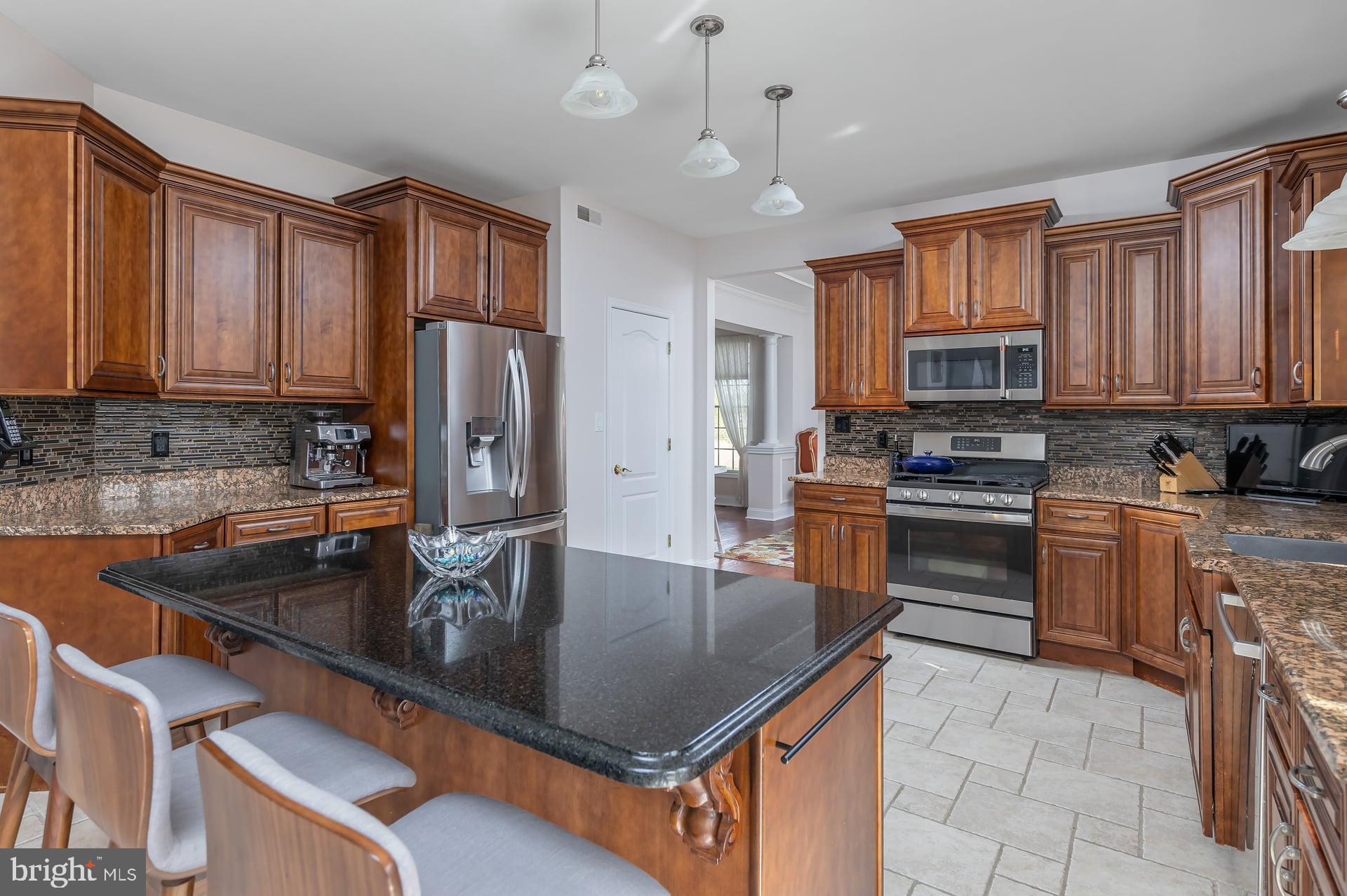 144 Point Airy Road Pilesgrove, NJ 08098 - Photo 13 of 65 a kitchen with kitchen island granite countertop a sink a counter top space appliances and cabinets