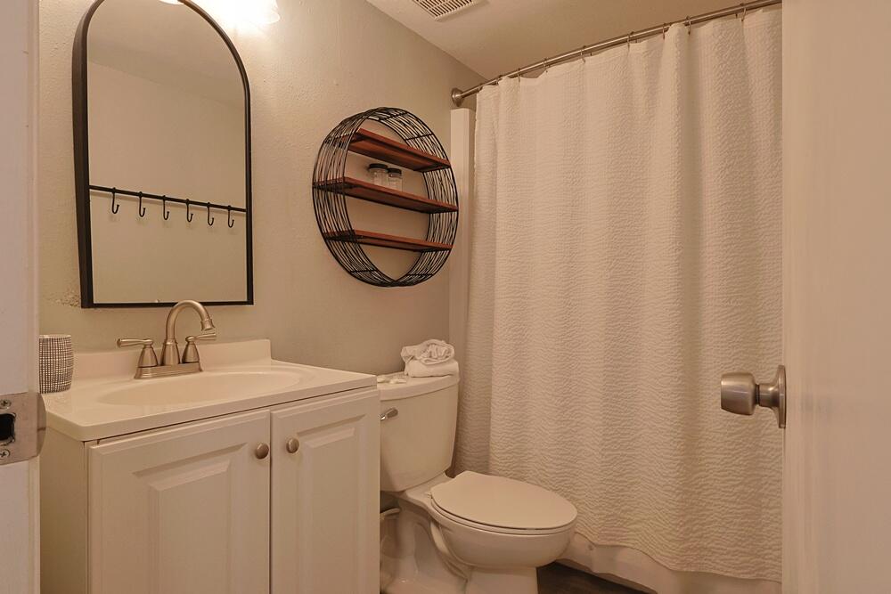909 Santa Rosa Boulevard, Unit 528 Fort Walton Beach, FL 32548 - Photo 20 of 66 a bathroom with a toilet sink vanity and mirror