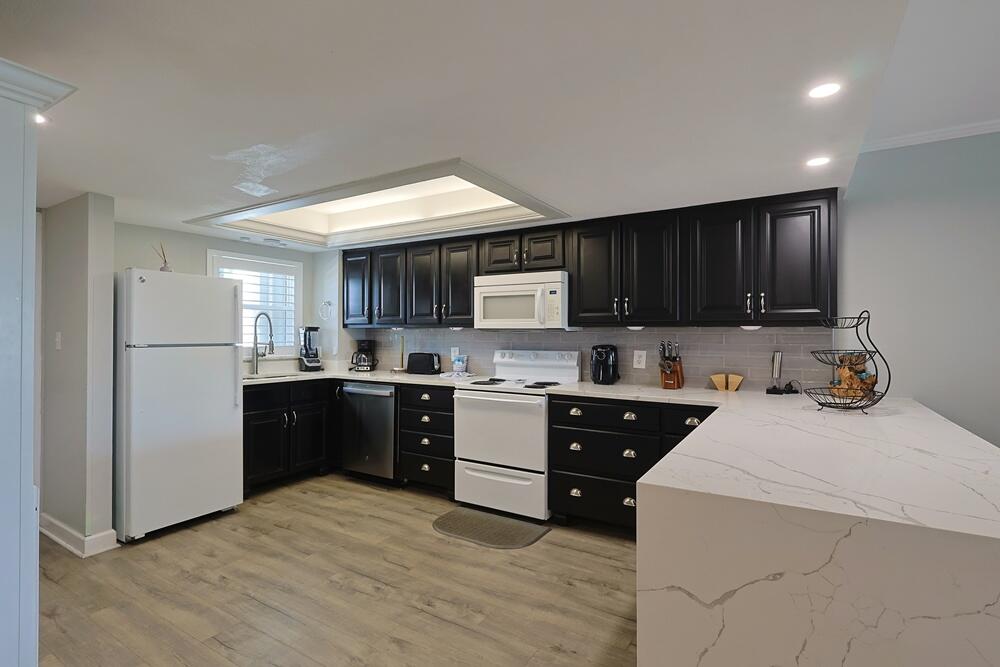 909 Santa Rosa Boulevard, Unit 528 Fort Walton Beach, FL 32548 - Photo 3 of 66 a kitchen with a sink a stove a refrigerator and cabinets