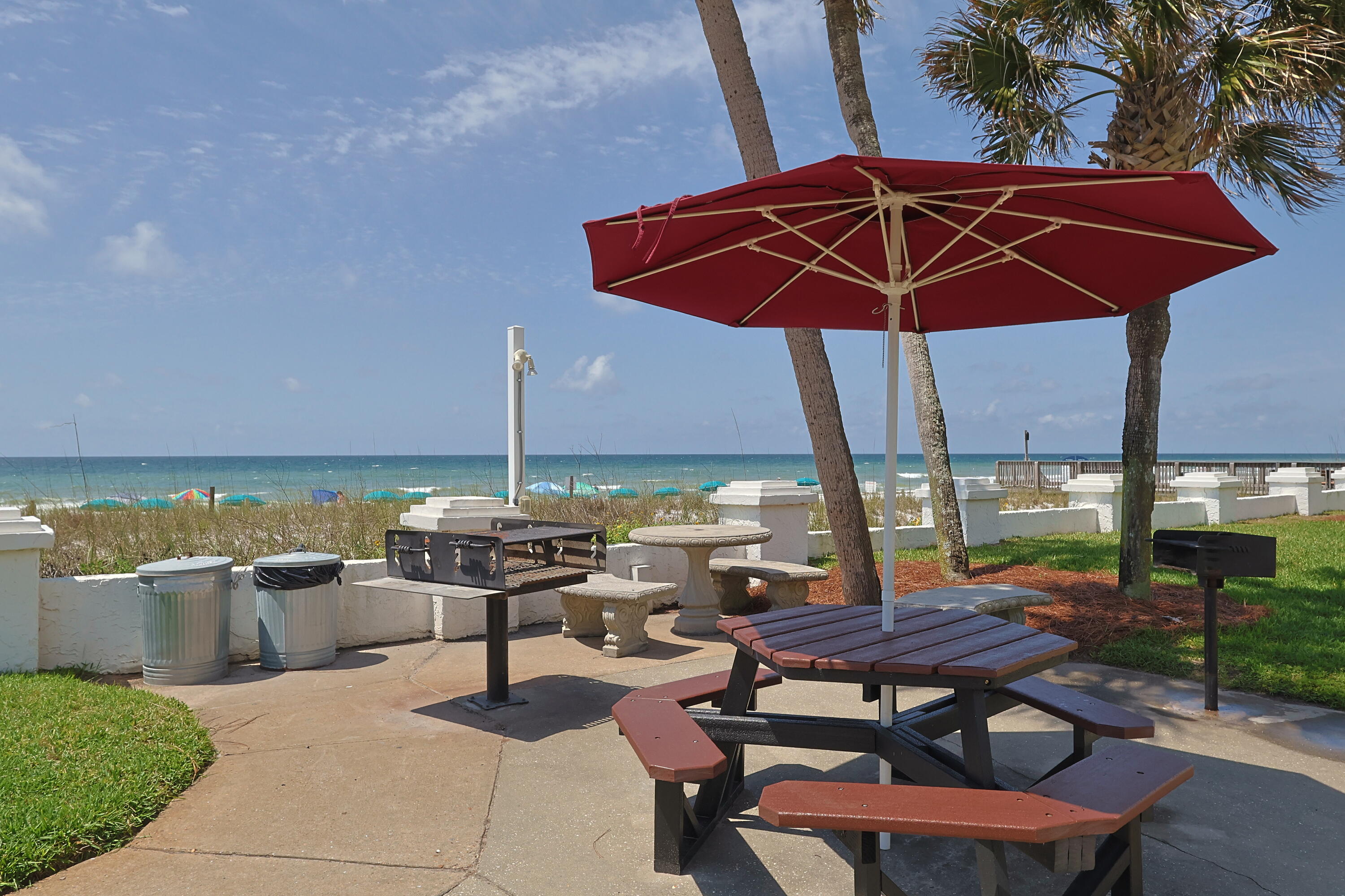 909 Santa Rosa Boulevard, Unit 528 Fort Walton Beach, FL 32548 - Photo 39 of 66 a view of a patio with a table chairs and a umbrella