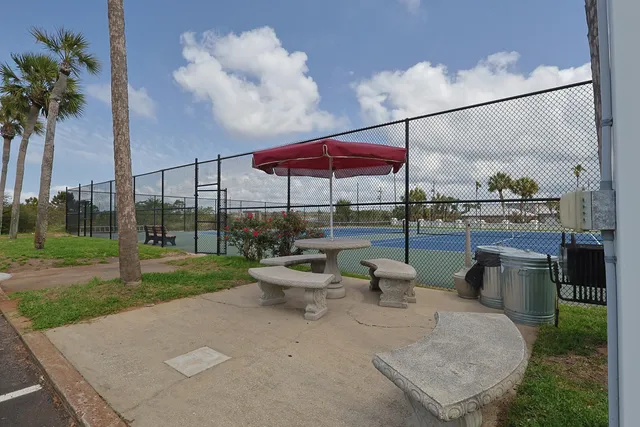 a view of a house with swimming pool and sitting area