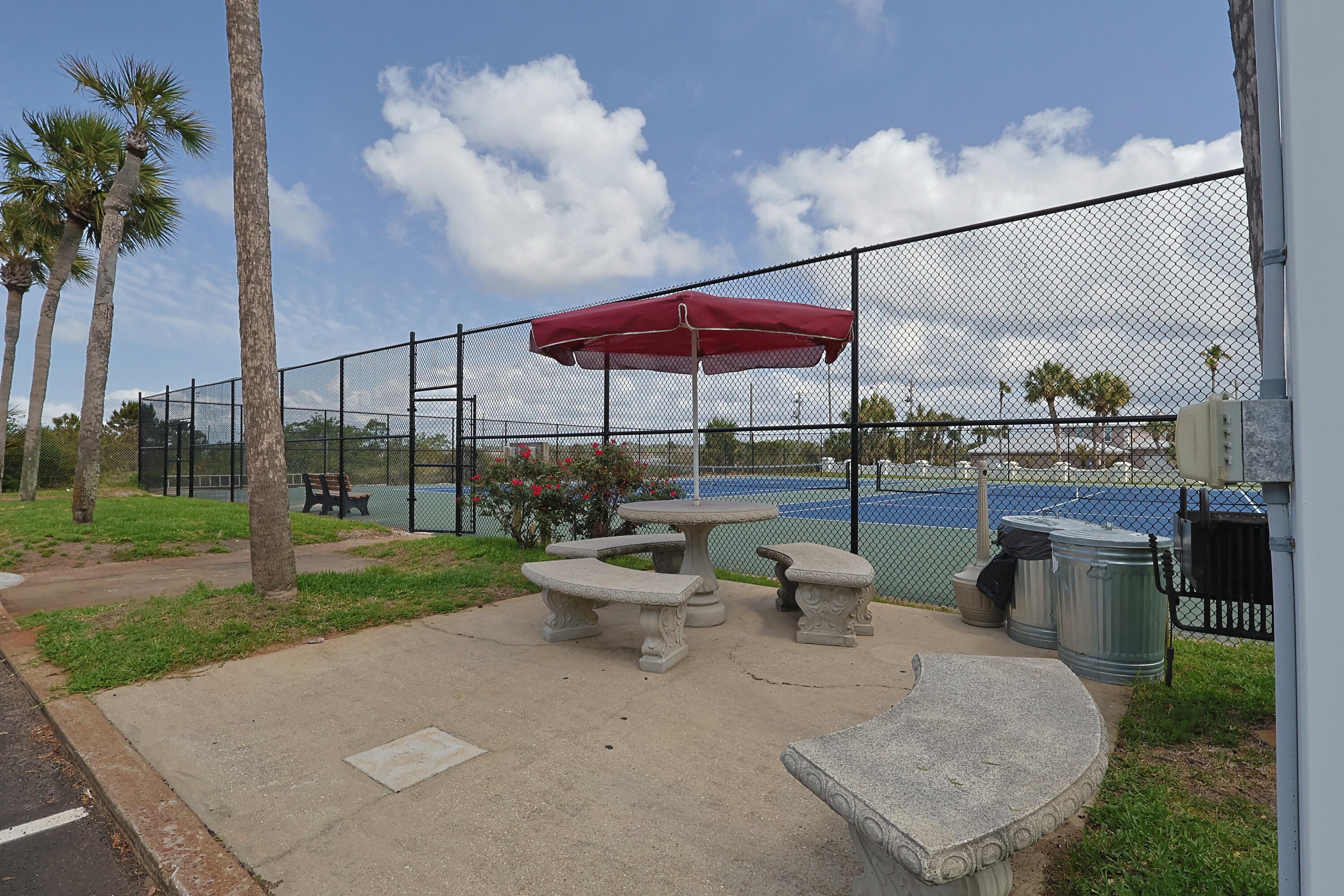 909 Santa Rosa Boulevard, Unit 528 Fort Walton Beach, FL 32548 - Photo 40 of 66 a view of a patio with couches and table under an umbrella