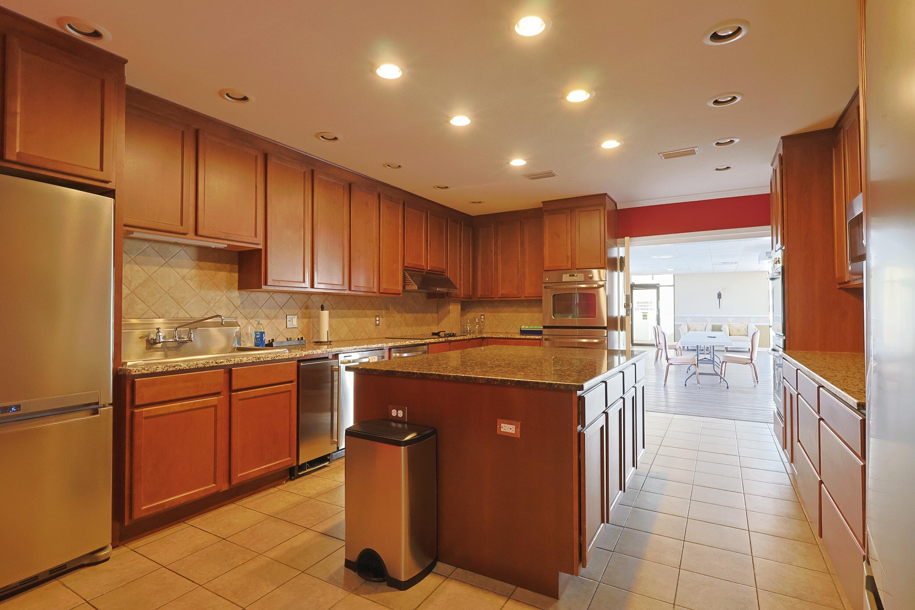 909 Santa Rosa Boulevard, Unit 528 Fort Walton Beach, FL 32548 - Photo 58 of 66 a kitchen with stainless steel appliances granite countertop a sink counter space cabinets and a large window