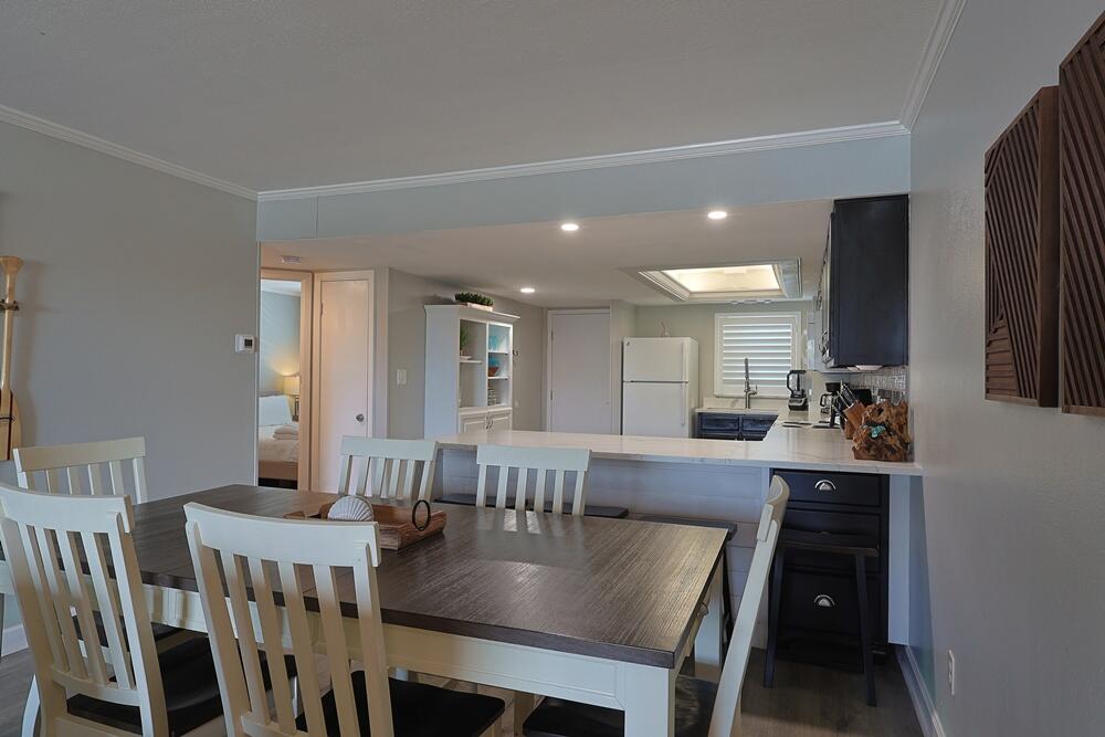909 Santa Rosa Boulevard, Unit 528 Fort Walton Beach, FL 32548 - Photo 6 of 66 a view of a dining room with furniture and wooden floor