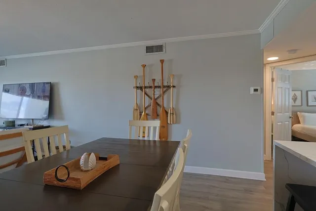 a living room with furniture a flat screen tv and a window