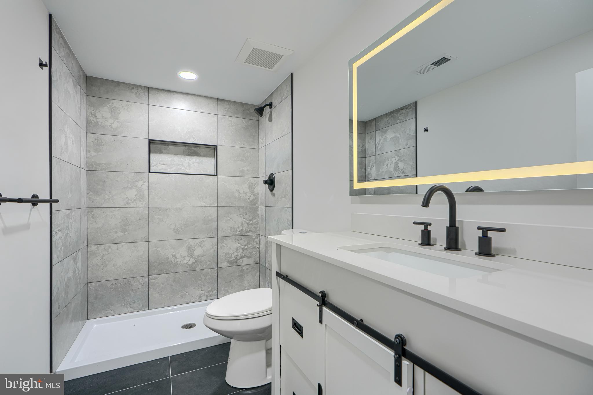 3410 Pinkney Road Baltimore, MD 21215 - Photo 43 of 55 a bathroom with a sink toilet and shower