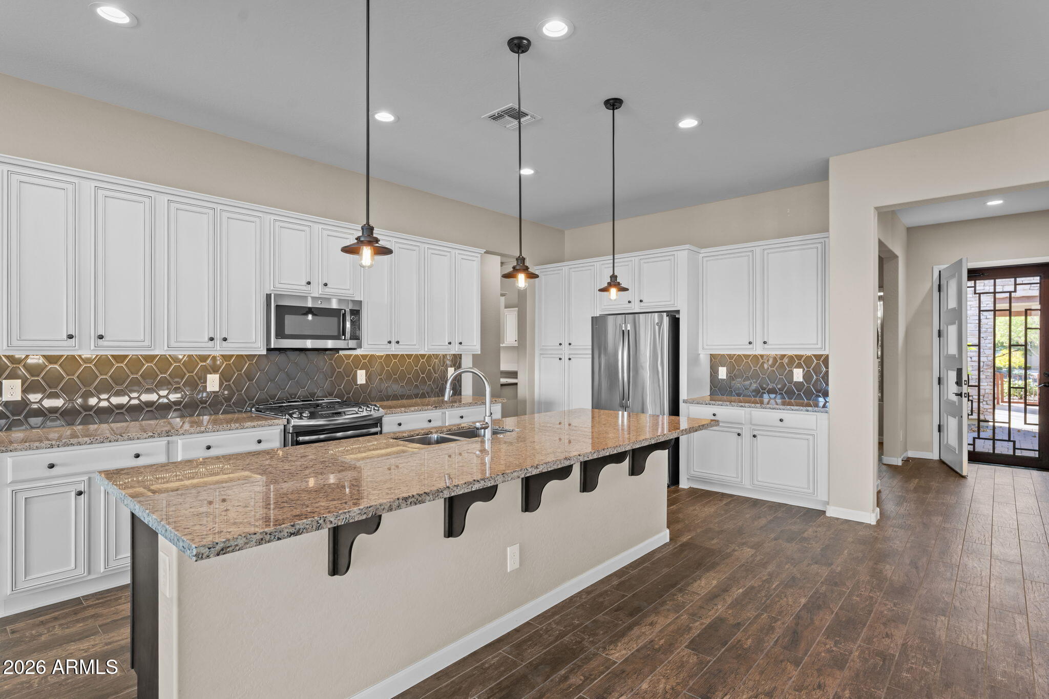 3675 Gold Ridge Road Wickenburg, AZ 85390 - Photo 2 of 58 a large kitchen with stainless steel appliances kitchen island a large island in the center