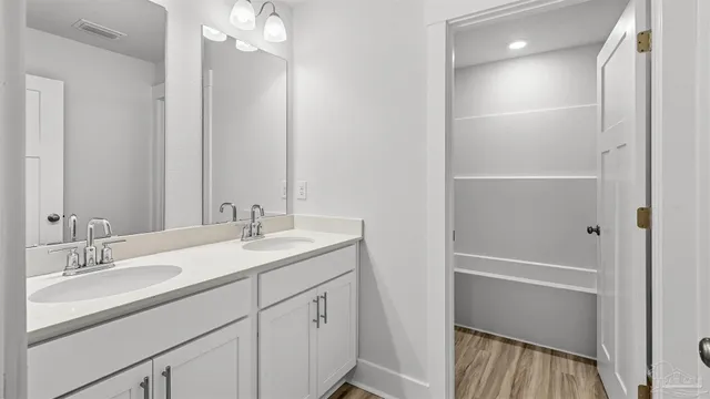 a bathroom with a sink double vanity and a mirror