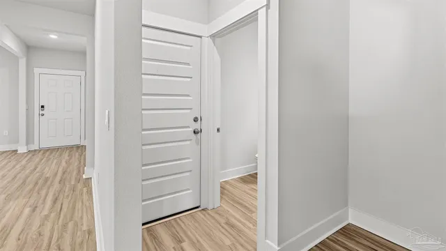 a view of a room with wooden floor