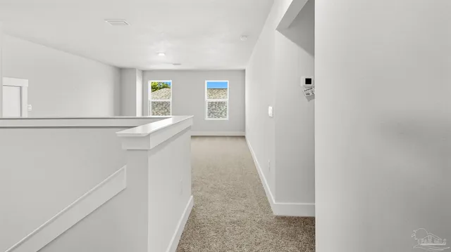 a view of hallway with furniture and window