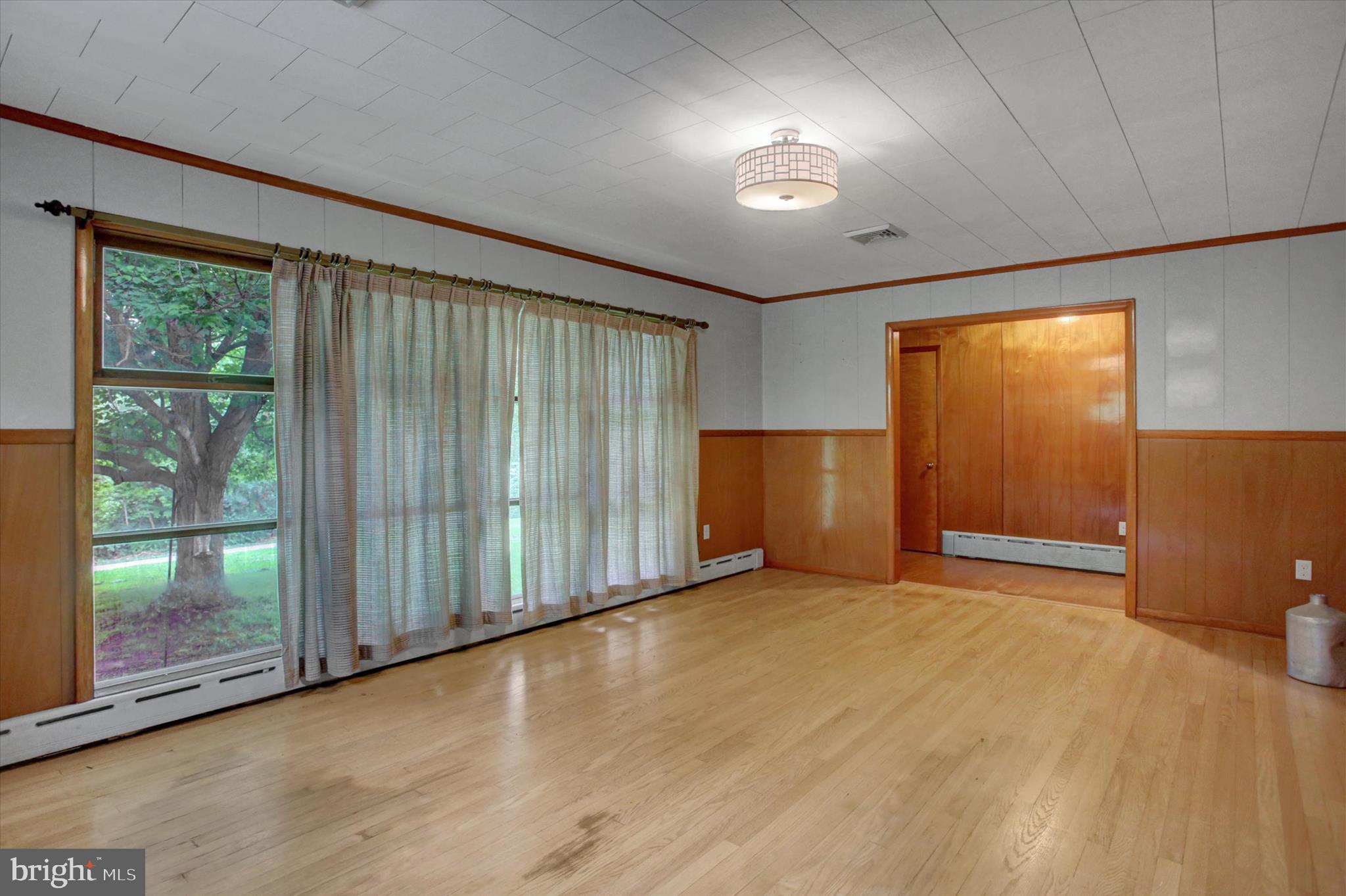 5156 Peach Orchard Road McConnellsburg, PA 17233 - Photo 9 of 34 a view of an empty room with wooden floor and a window