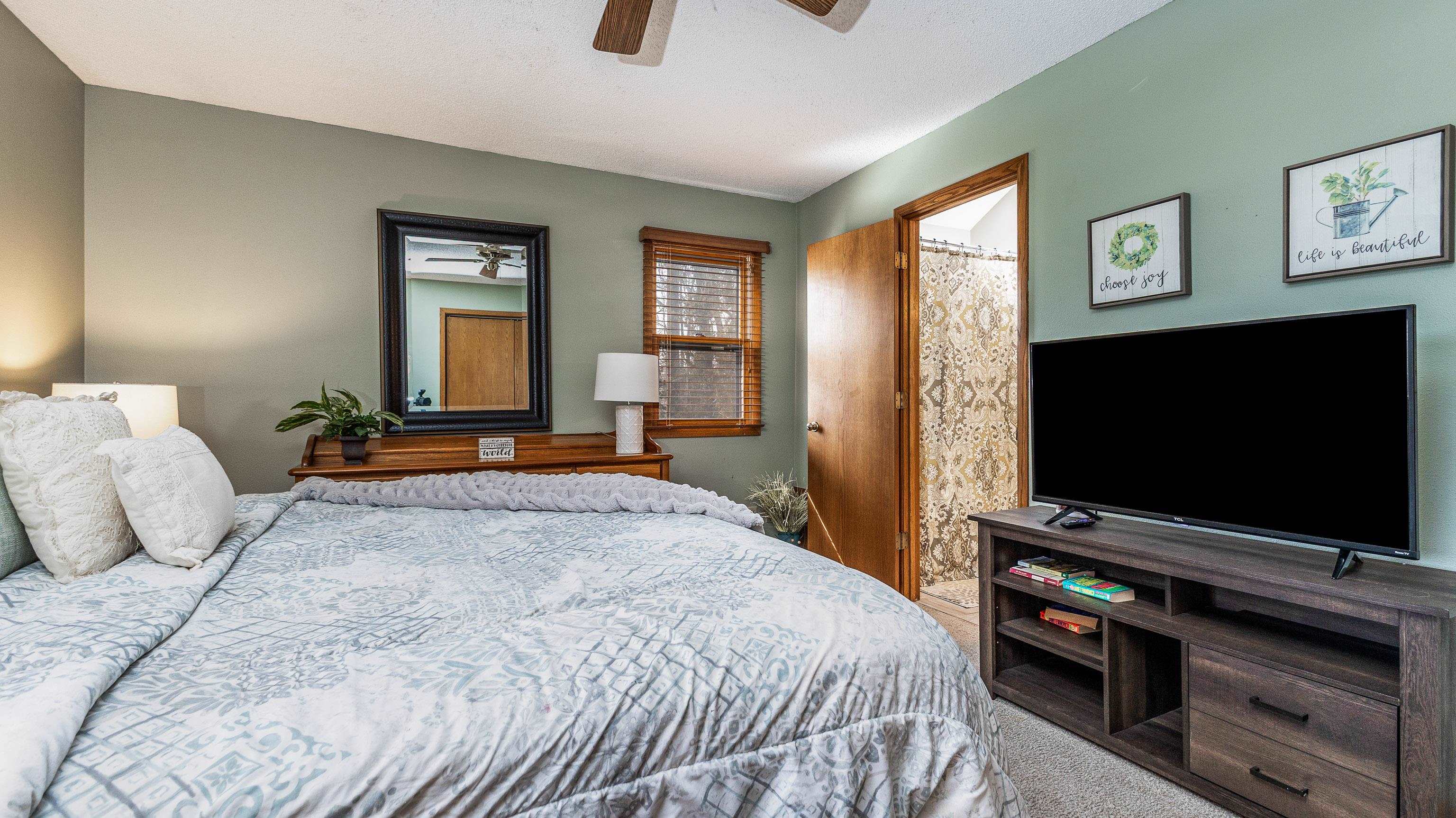 7 Colony Lane Galena, IL 61036 - Photo 14 of 36 a bedroom with a bed and a flat screen tv on dresser