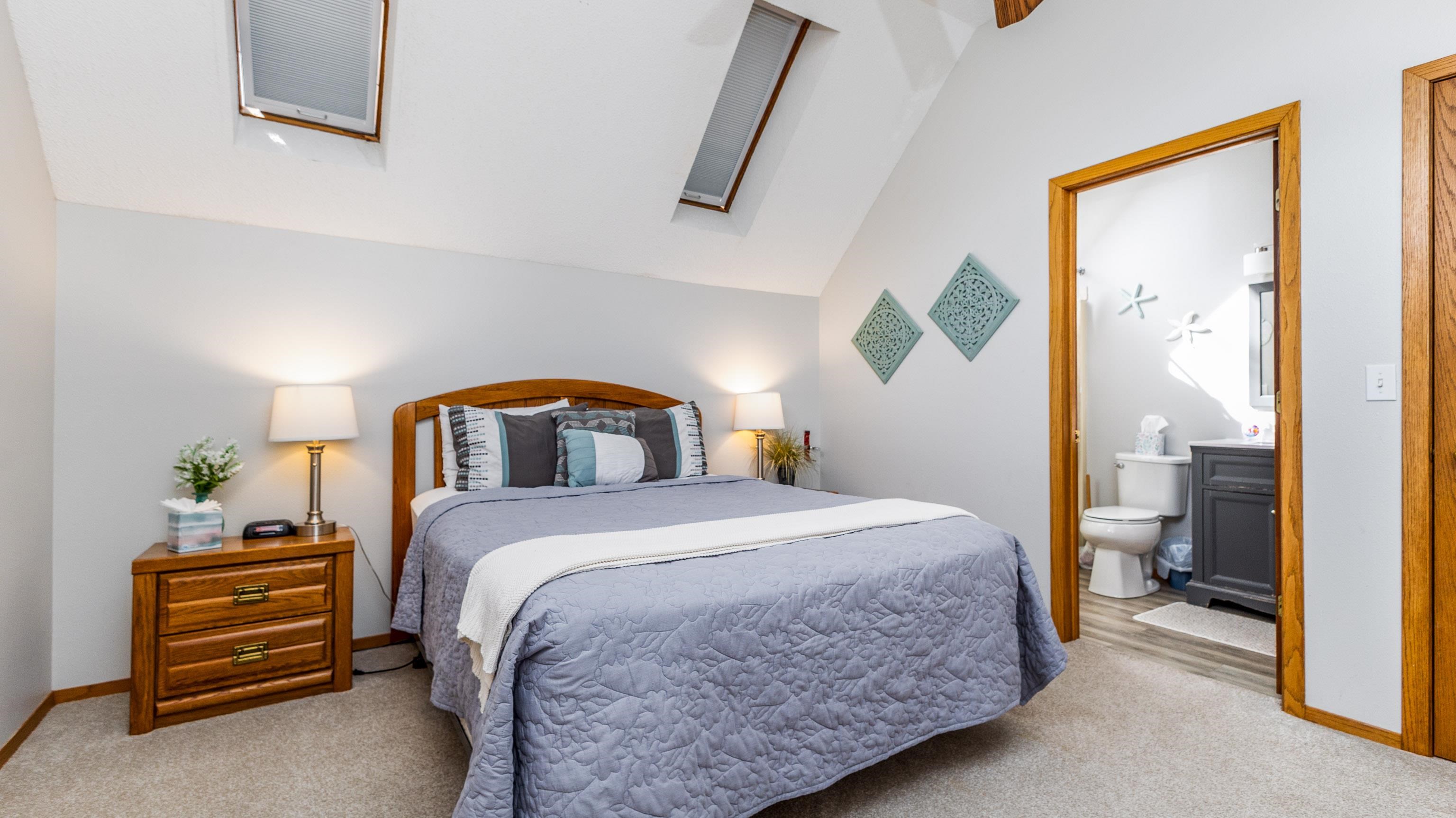 7 Colony Lane Galena, IL 61036 - Photo 16 of 36 a bedroom with a bed and a painting on the wall