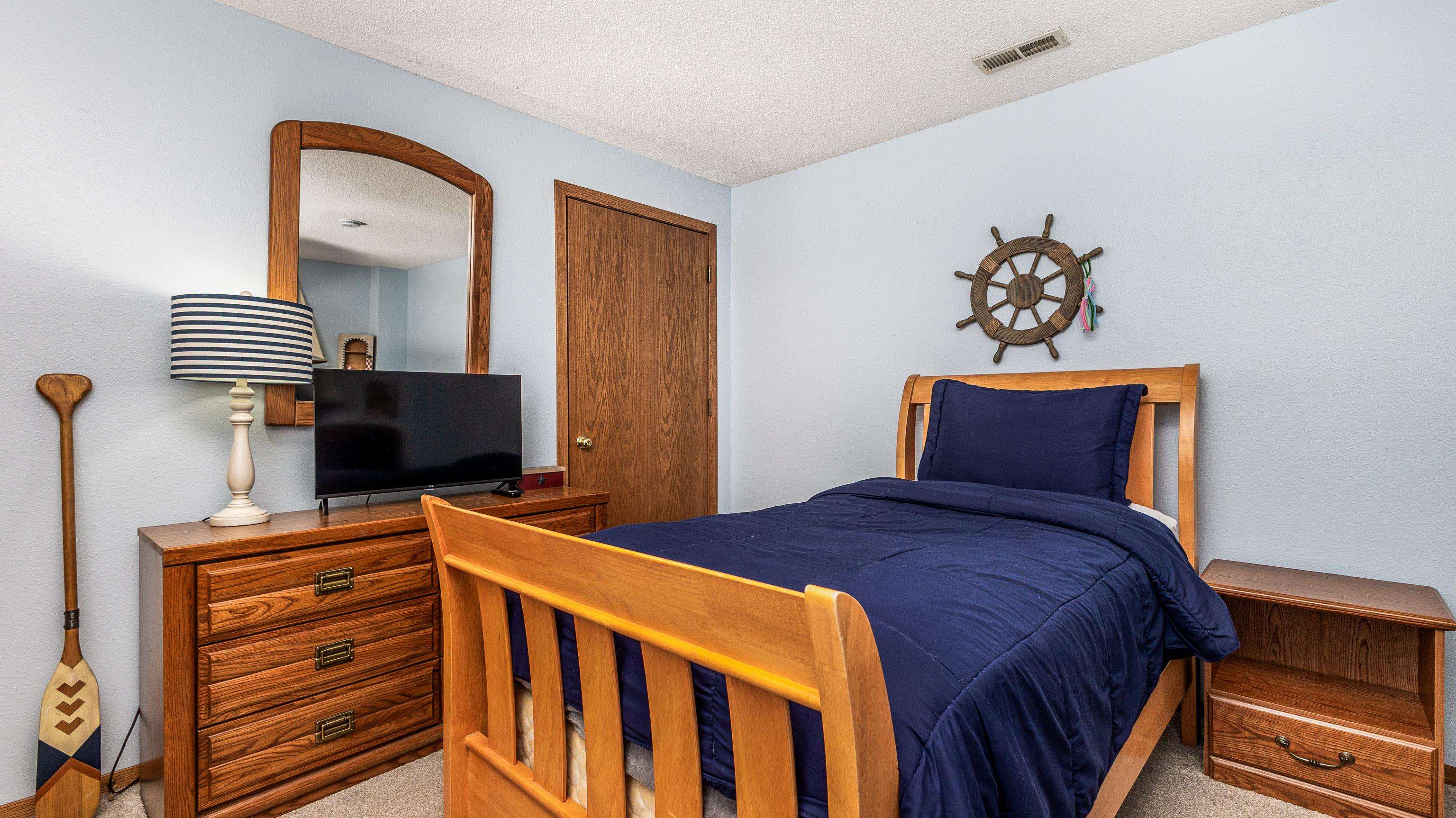 7 Colony Lane Galena, IL 61036 - Photo 26 of 36 a bedroom with a bed and a chandelier