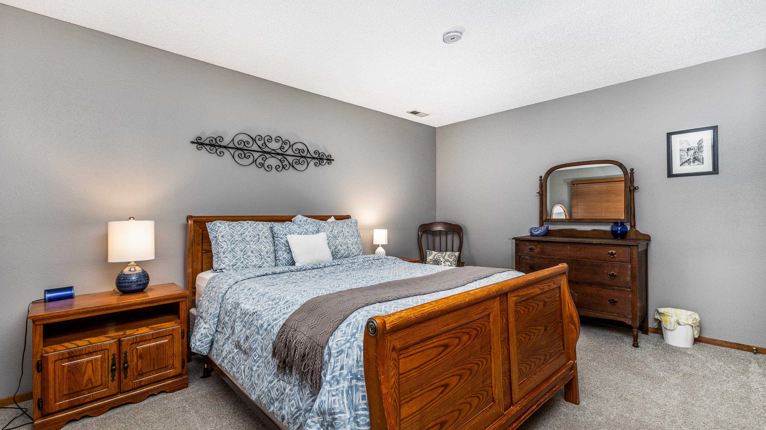 7 Colony Lane Galena, IL 61036 - Photo 27 of 36 a bedroom with a bed and a lamp on dresser