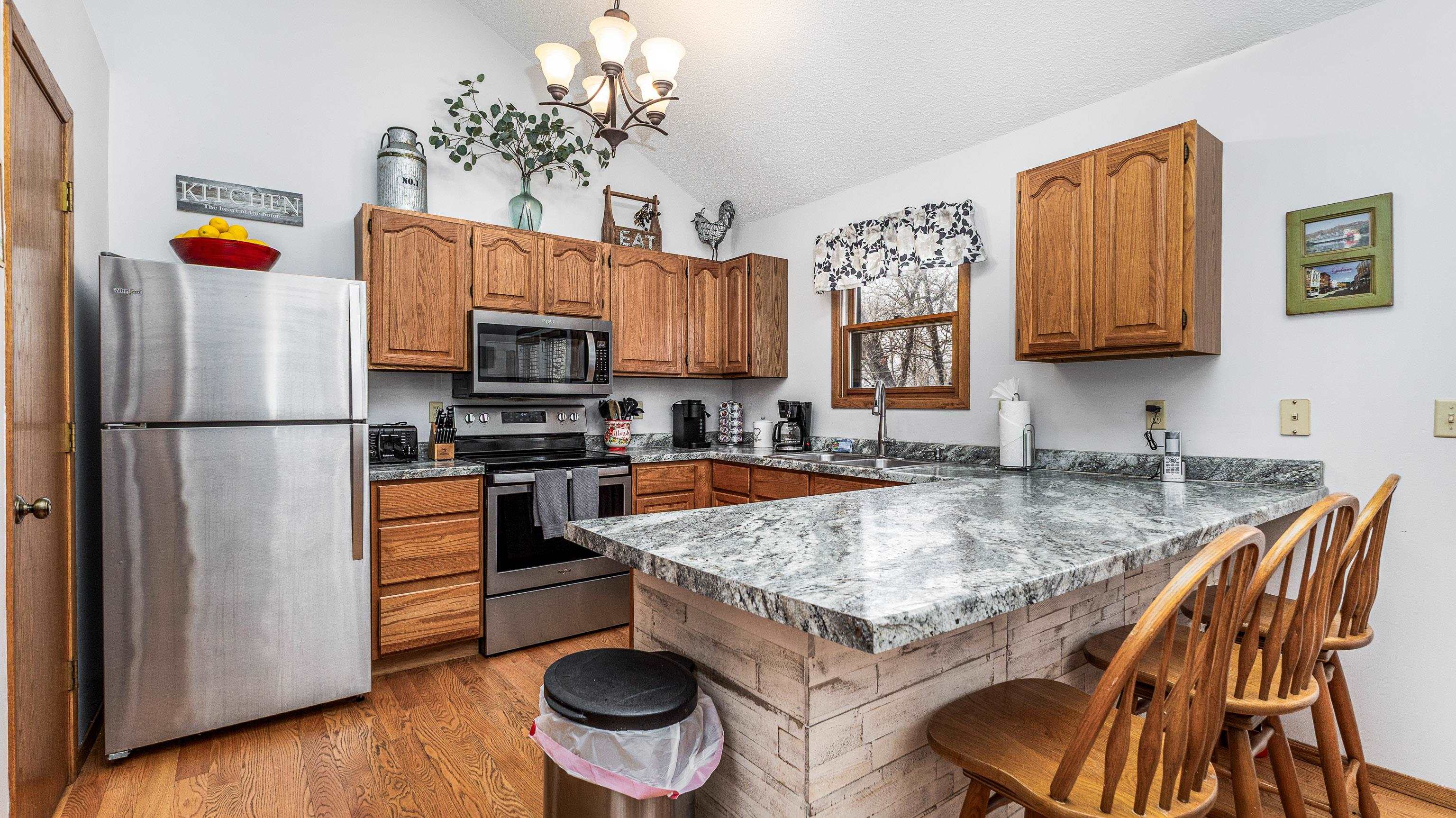 7 Colony Lane Galena, IL 61036 - Photo 8 of 36 a kitchen with a refrigerator and a stove top oven