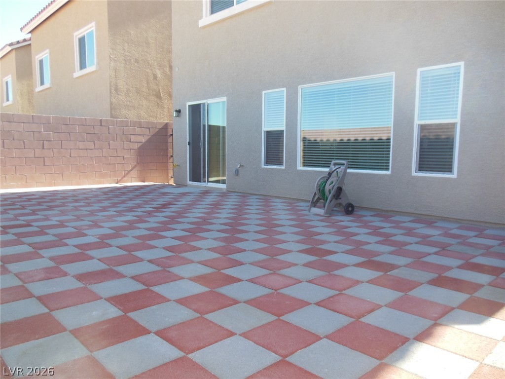 6390 Jackson Spring Road Las Vegas, NV 89118 - Photo 27 of 27 A spacious outdoor patio with a distinctive checkerboard-patterned paver surface offers abundant entertainment possibilities.