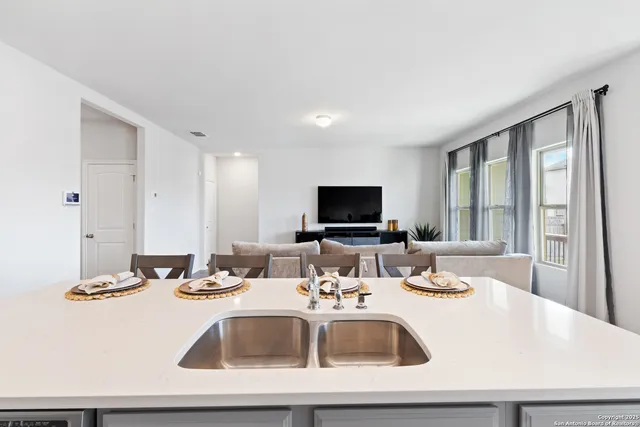 a kitchen with a sink and a large window