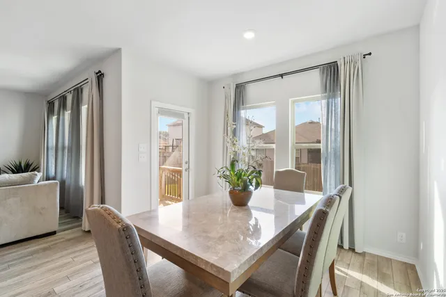 a view of a dining room with furniture window and wooden floor