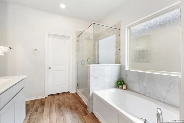 a bathroom with a bathtub and a shower