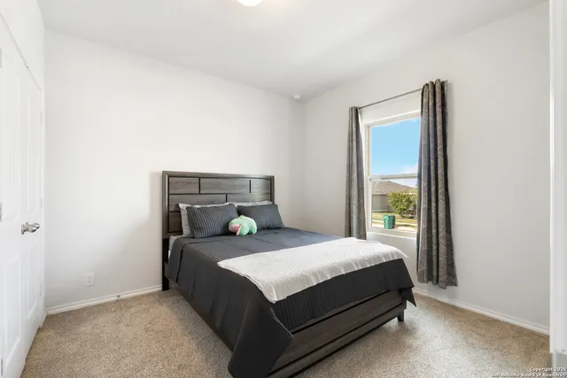 a bedroom with a bed and window