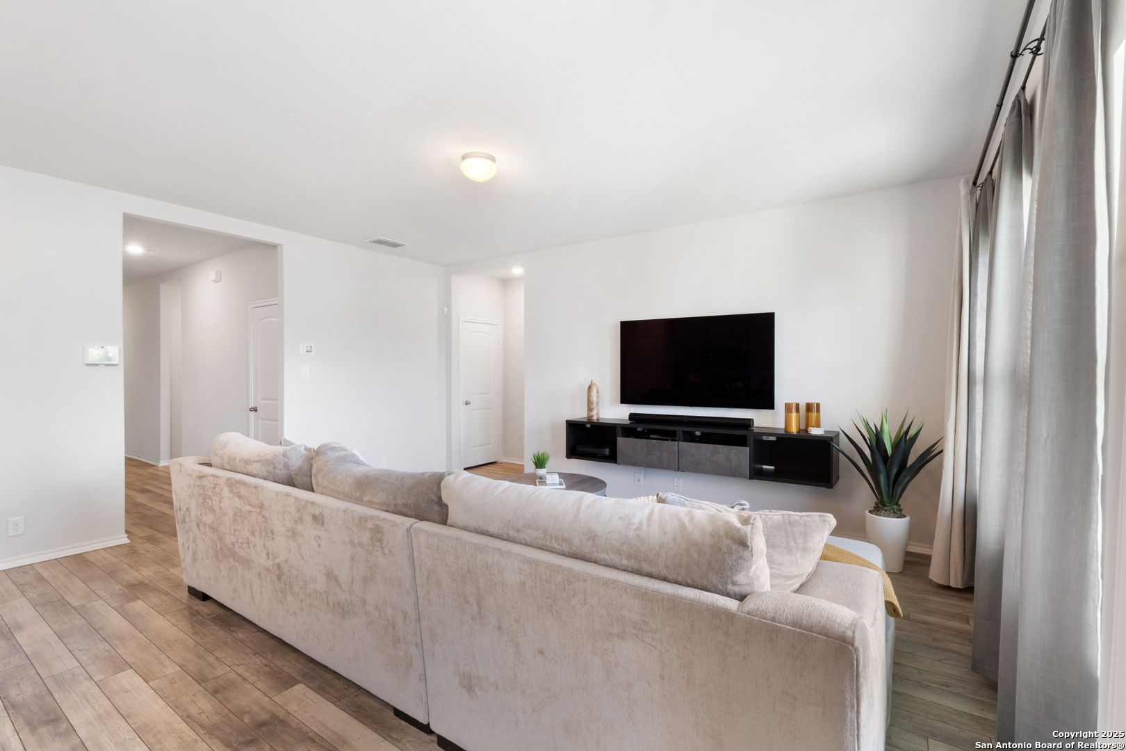 6847 Alaskan Wy. Converse, TX 78109 - Photo 7 of 32 a living room with furniture and a flat screen tv