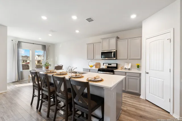 a kitchen that has a table and chairs in it