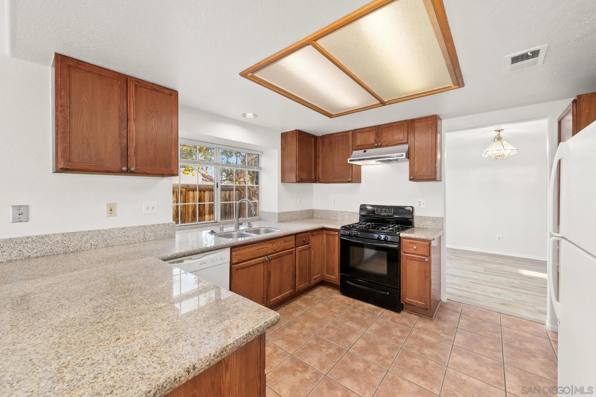 403 Calle Corazon Oceanside, CA 92057 - Photo 16 of 40 a kitchen with stainless steel appliances granite countertop a sink stove and refrigerator