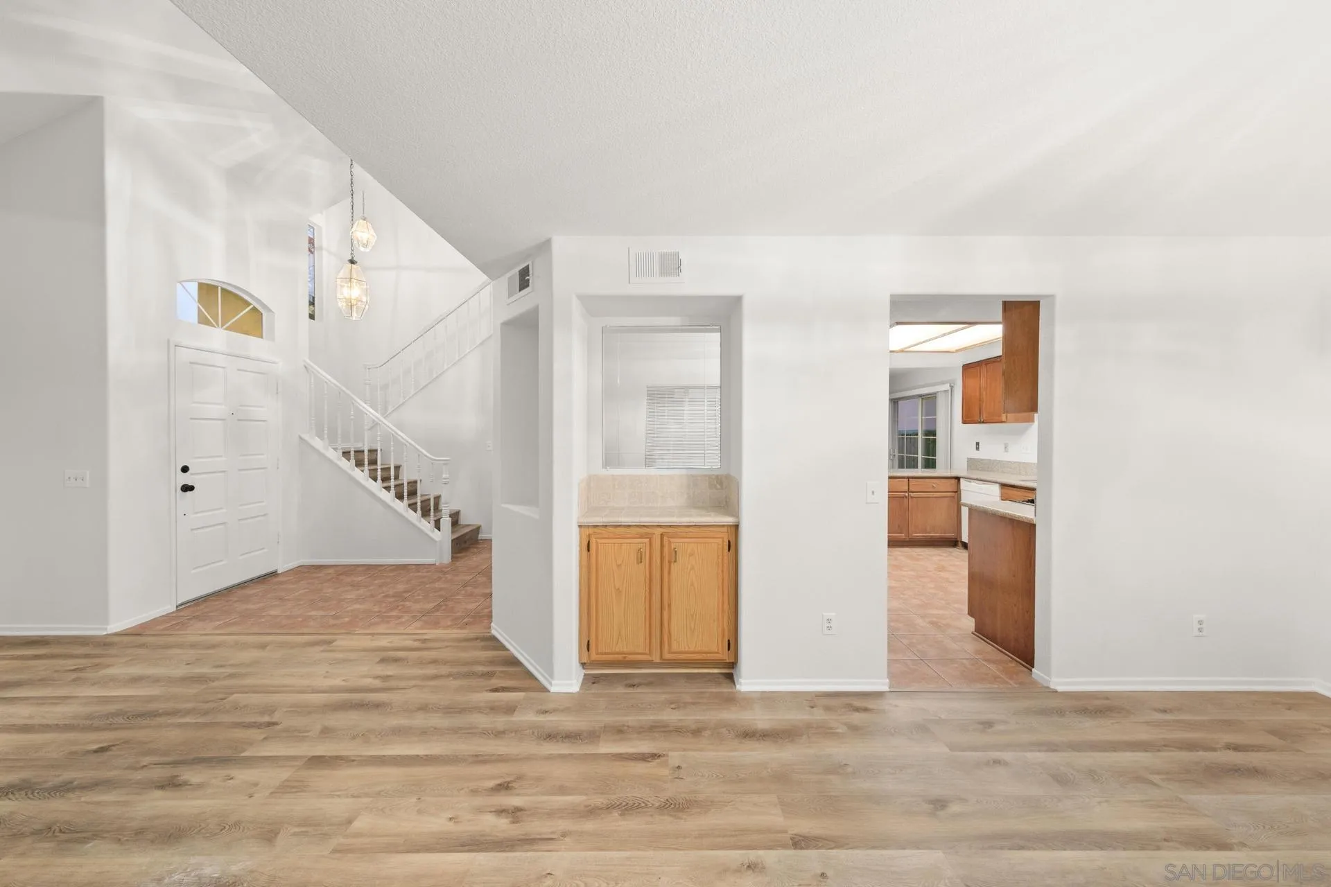 403 Calle Corazon Oceanside, CA 92057 - Photo 19 of 40 a view of a room with wooden floor and stairs
