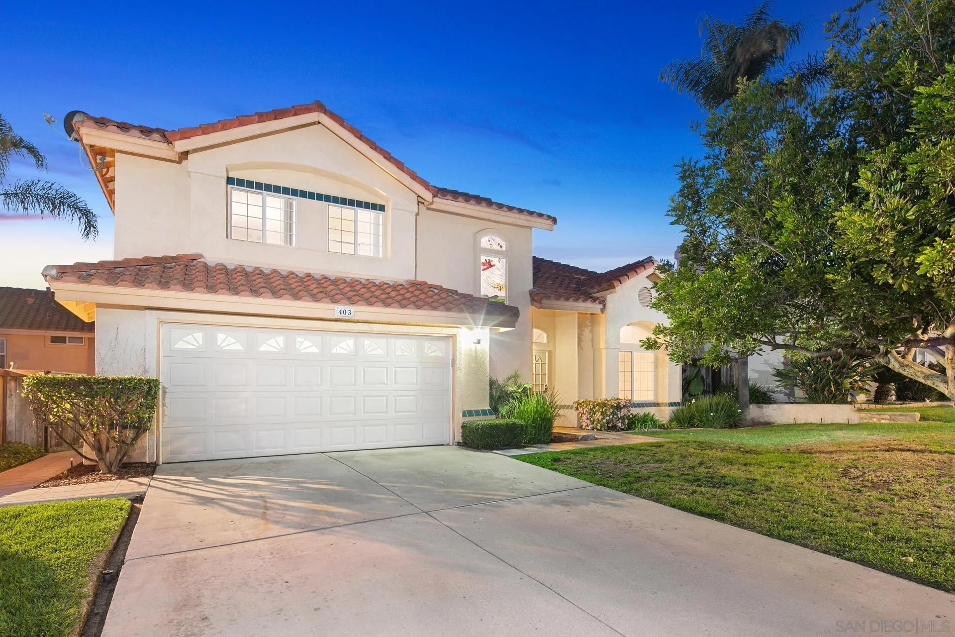 403 Calle Corazon Oceanside, CA 92057 - Photo 2 of 40 a front view of a house with a yard and garage