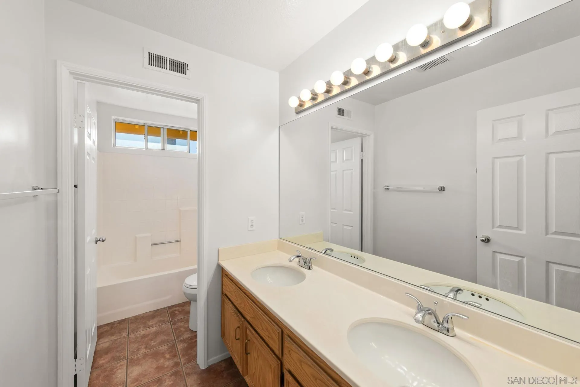 403 Calle Corazon Oceanside, CA 92057 - Photo 22 of 40 a bathroom with a sink a mirror and a shower