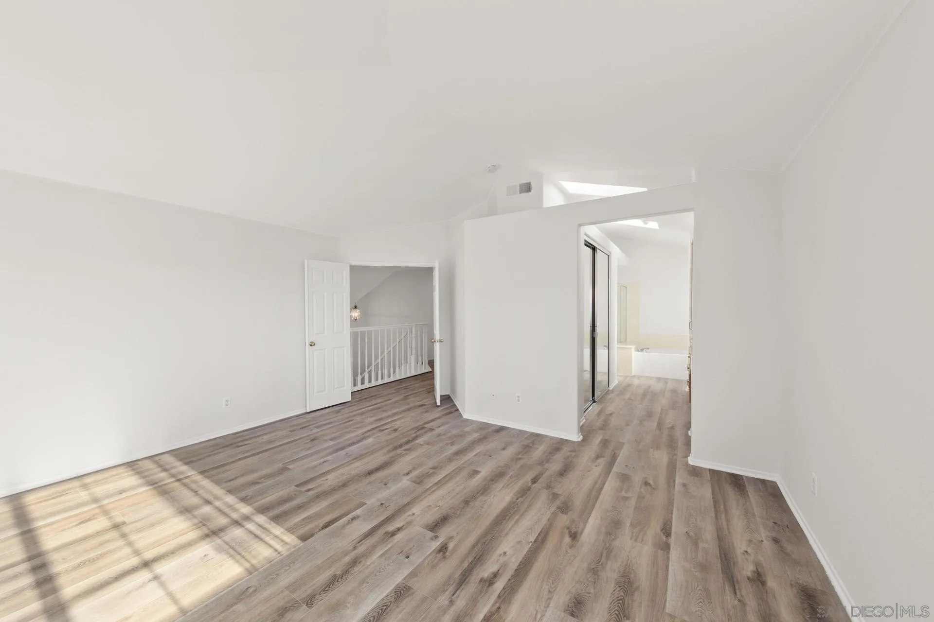 403 Calle Corazon Oceanside, CA 92057 - Photo 29 of 40 a view of a room with wooden floor and white walls