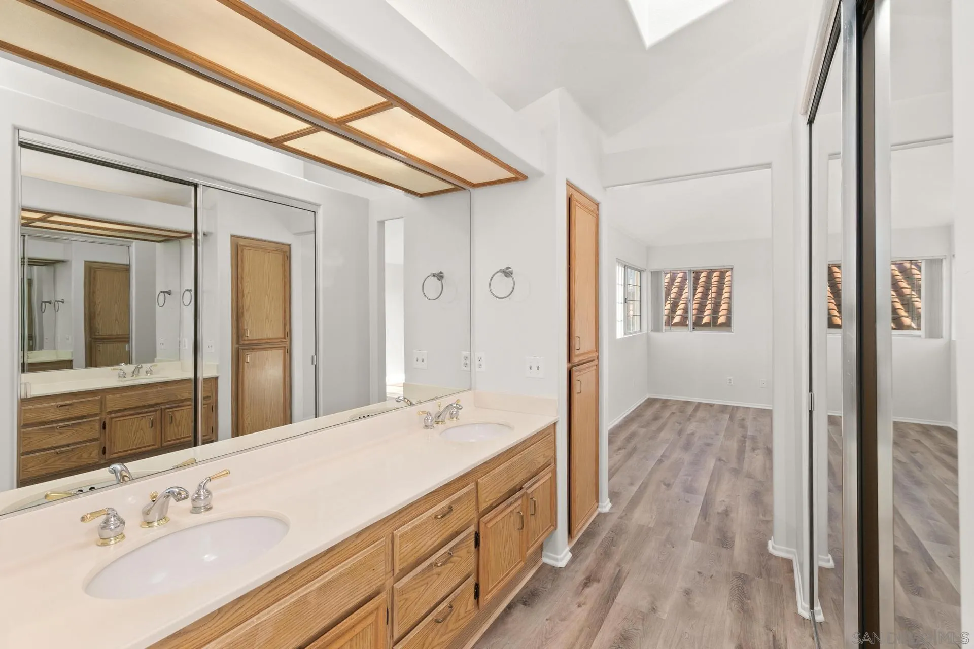 403 Calle Corazon Oceanside, CA 92057 - Photo 32 of 40 a bathroom with a double vanity sink and mirror