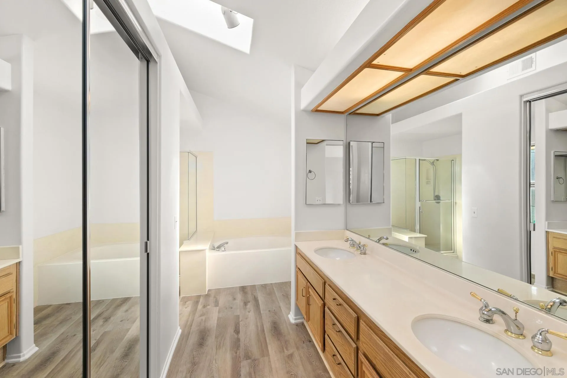 403 Calle Corazon Oceanside, CA 92057 - Photo 34 of 40 a bathroom with a sink a mirror and a bathtub