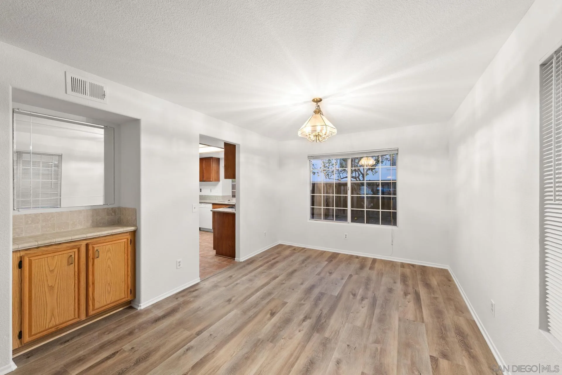 403 Calle Corazon Oceanside, CA 92057 - Photo 4 of 40 a view of empty room with wooden floor and window