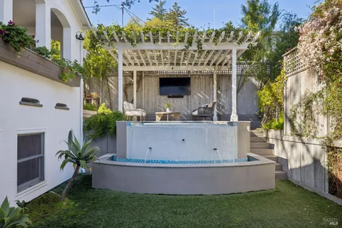 a view of house and garden with swimming pool