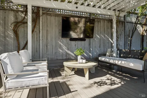a building outdoor space with patio furniture and potted plants