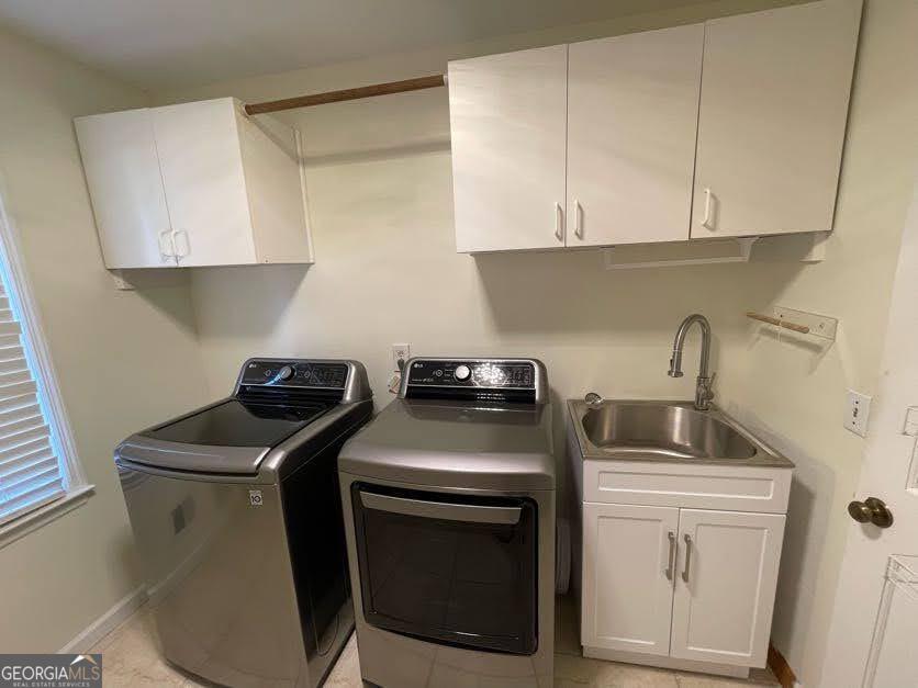 1502 Eryn Circle Suwanee, GA 30024 - Photo 12 of 57 a kitchen with sink a stove and cabinets