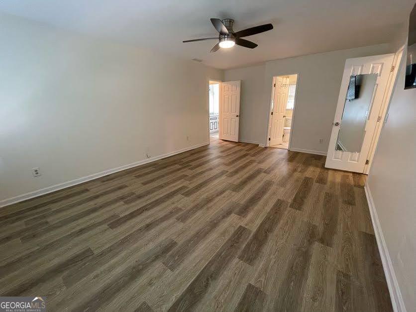 1502 Eryn Circle Suwanee, GA 30024 - Photo 19 of 57 a view of empty room with wooden floor and fan