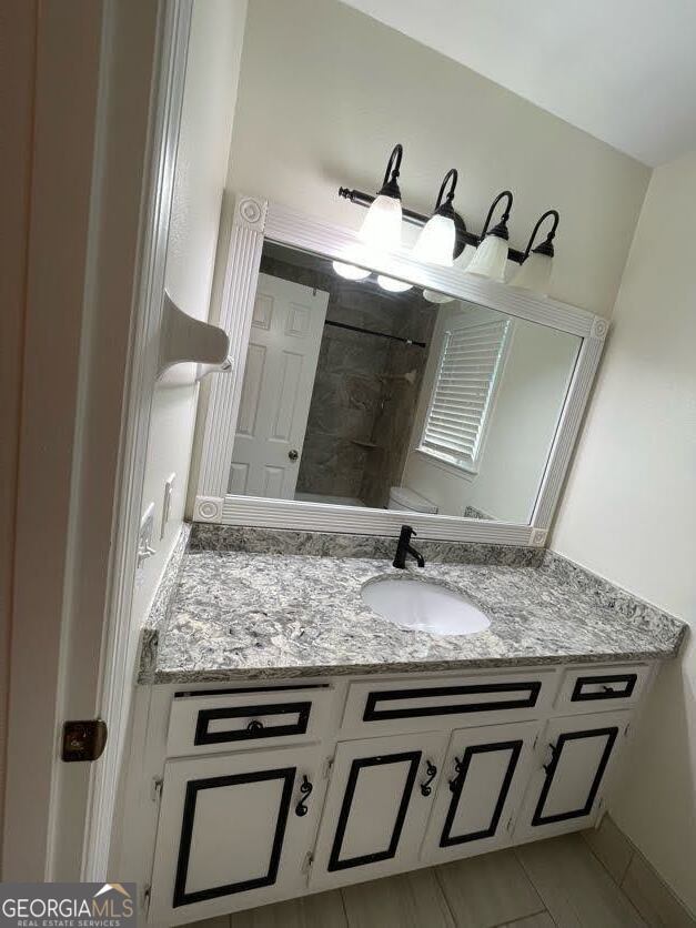 1502 Eryn Circle Suwanee, GA 30024 - Photo 24 of 57 a bathroom with a granite countertop sink and a mirror