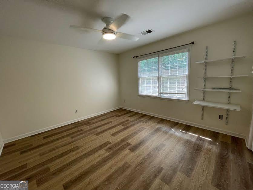 1502 Eryn Circle Suwanee, GA 30024 - Photo 26 of 57 wooden floor in an empty room with a window