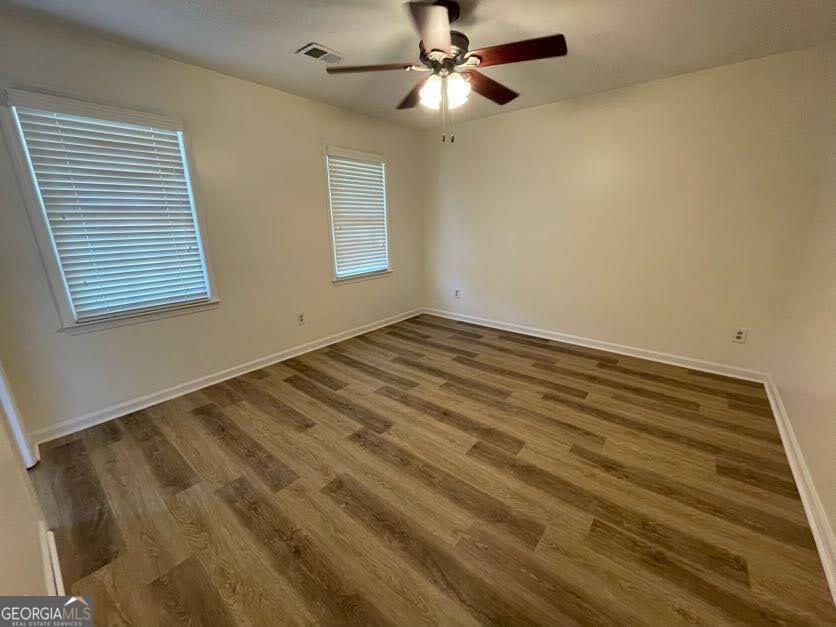 1502 Eryn Circle Suwanee, GA 30024 - Photo 28 of 57 a view of empty room with wooden floor and fan