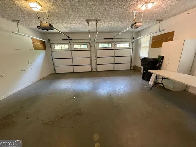 a bedroom with a bed wooden floor and window