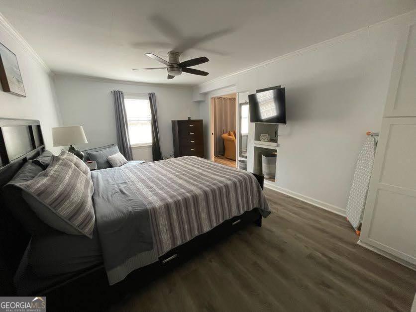 1502 Eryn Circle Suwanee, GA 30024 - Photo 37 of 57 a bedroom with a bed wooden floor and window