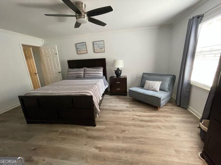 1502 Eryn Circle Suwanee, GA 30024 - Photo 38 of 57 a bedroom with a bed lamp and a fireplace